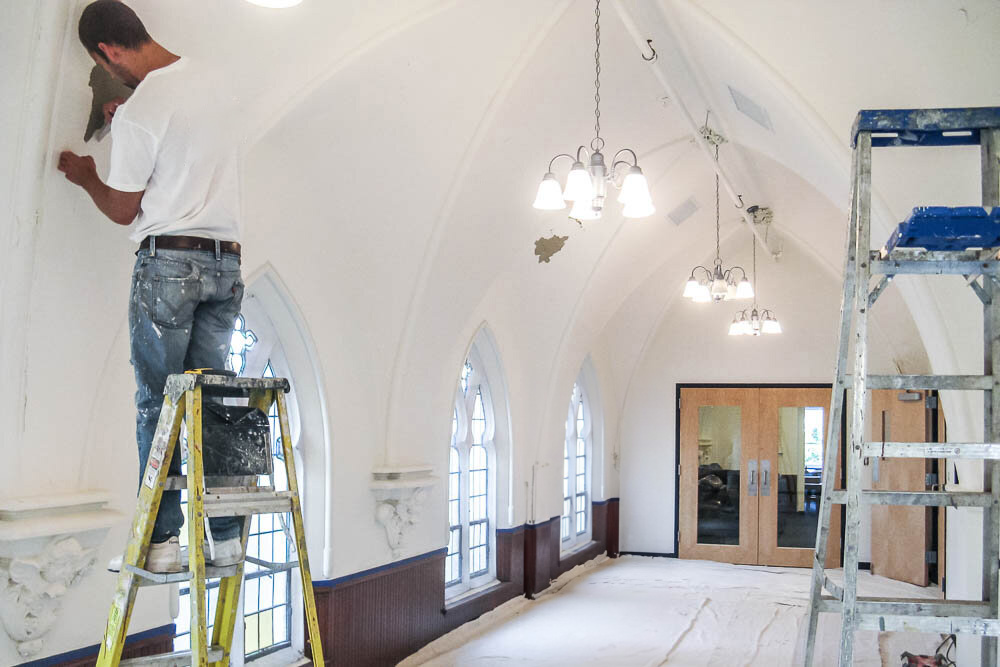 Painter renovating building